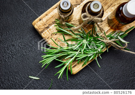 Rosemary essential oil on black background 80526176