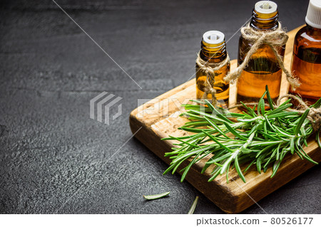Rosemary essential oil on black background Rosemary essential oil on black background 80526177