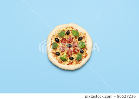 Vegetarian pizza uncooked on blue table. Raw vegan pizza, flat lay 80527230