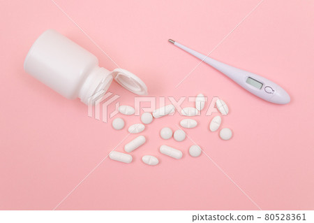White Pills or Tablets with Electronic Thermometer on Pink Background White Pills or Tablets with Electronic Thermometer on Pink Background 80528361