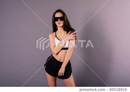 Young and beautiful dancer posing in studio 80528916