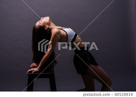 Young and beautiful dancer posing in studio 80528919