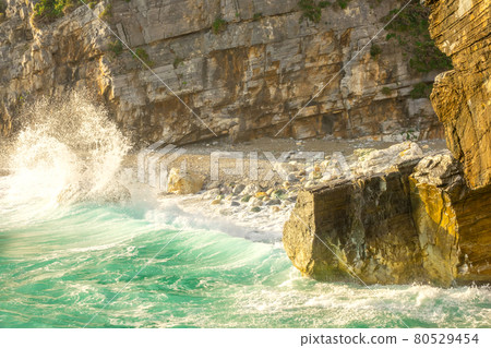 Morning Surf and Water Splashes on a Rocky Beach Morning Surf and Water Splashes on a Rocky Beach 80529454