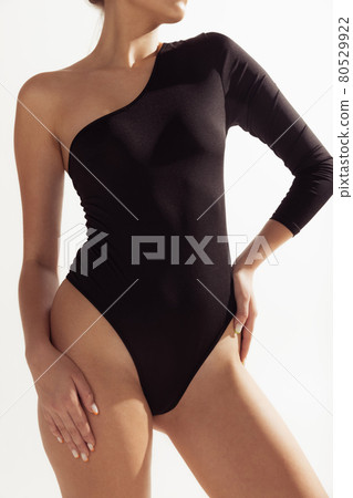 Close up female body in black underwear over white background. 80529922