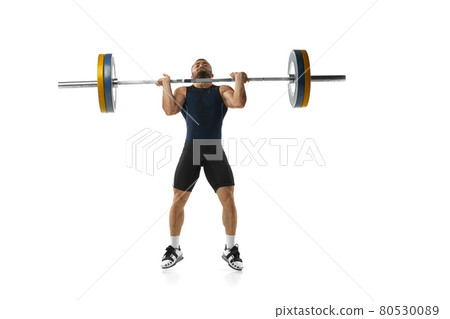 Full length portrait of a man in sportswear exercising with a weight isolated on white background 80530089