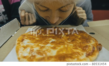 Girl eat pizza cheese four. Close up of young woman mouth greedily eating pizza and chewing in outdoor restaurant. Junk food. Pizza from open box. 80531454