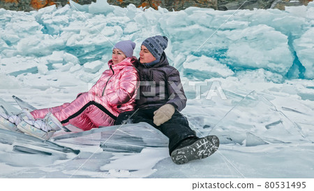 Couple has fun during winter walk against background of ice of f 80531495