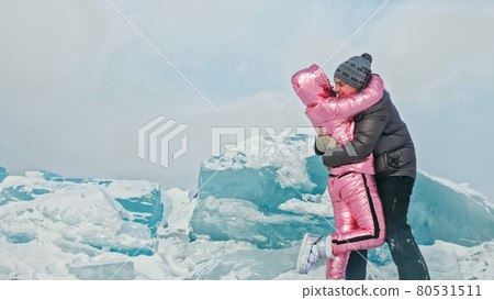 Couple has fun during winter walk against background of ice of f 80531511