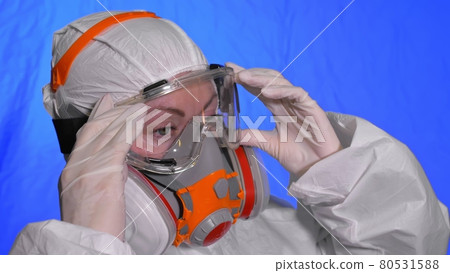 Scientist virologist in respirator. Woman close up look, wearing protective medical mask. Concept health safety N1H1 coronavirus epidemic 2019 nCoV. 80531588