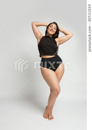 Young beautiful plump woman in cotton underwear on white background Young beautiful plump woman in cotton underwear on white background 80531934
