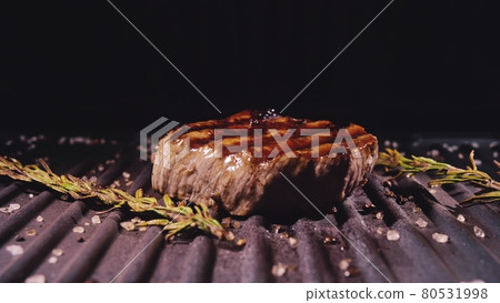 Delicious juicy meat steak cooking on grill. Prime beef fry on electric roaster, rosemary, black pepper, salt. Slow motion. Delicious juicy meat steak cooking on grill. Prime beef fry on electric roaster, rosemary, black pepper, salt. Slow motion. 80531998