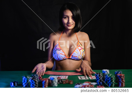 sexy women wearing bikini playing poker at the casino 80532665