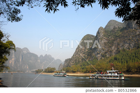 Boats on the Li River between Guilin and Yangshuo in Guangxi Province, China. The karst hills and river scenery have provided inspiration for artists and poets. Li River scenery, Guilin. Boats on the Li River between Guilin and Yangshuo in Guangxi Province, China. The karst hills and river scenery have provided inspiration for artists and poets. Li River scenery, Guilin. 80532866