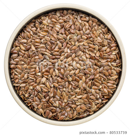 brown flax seeds in a round bowl 80533739