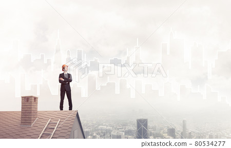 Engineer man standing on roof and looking away. Mixed media 80534277