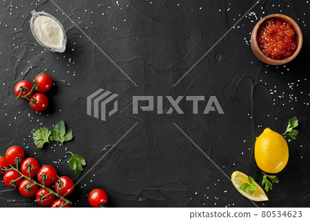Food background with tomatoes, lemon, sauce and caviar nd with copyspace 80534623