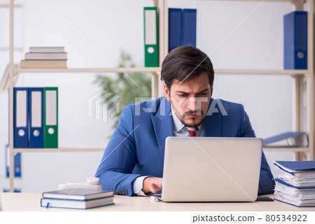 Young male employee working in the office Young male employee working in the office 80534922