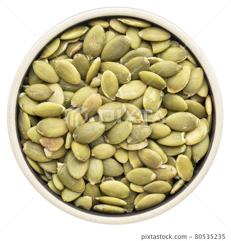 pumpkin seeds in a round bowl pumpkin seeds in a round bowl 80535235