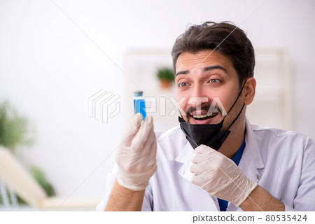 Young male chemist in pandemic concept Young male chemist in pandemic concept 80535424