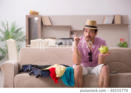 Young man preparing for trip at home Young man preparing for trip at home 80535779