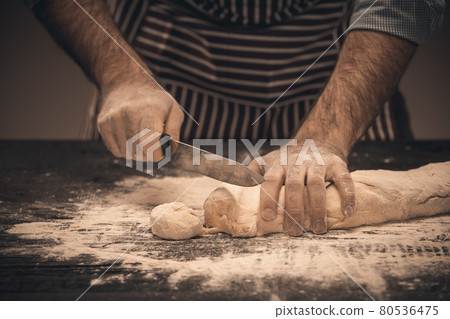 Male hands knead the dough. Male hands knead the dough. 80536475