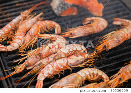 Process of cooking fresh red langoustine shrimps, prawns on grill - street food Process of cooking fresh red langoustine shrimps, prawns on grill - street food 80536909