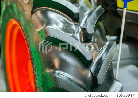 Close up view of heavy tractor tire and wheel at farming exhibition 80536917