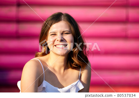 Smiling white female is posing outdoors at summer day. Smiling white female is posing outdoors at summer day. 80537834