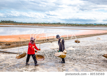 Phetchaburi Salt flats Naklua, farms and farmers collecting salt in Phetchaburi, Thailand 80538569