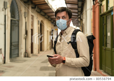 Masked male tourist walks at closed market during coronavirus pandemic, lockdown on Cyprus. Man in mask walks through market in city center. No tourists, bankruptcy of small businesses under COVID 19 Masked male tourist walks at closed market during coronavirus pandemic, lockdown on Cyprus. Man in mask walks through market in city center. No tourists, bankruptcy of small businesses under COVID 19 80538794