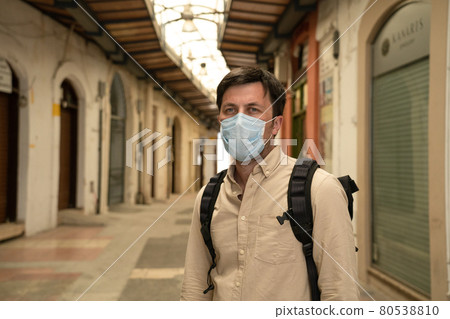 Empty streets city, closed shops, no people market of Cyprus city of paphos during national lockdown.Bankrupt during coronavirus outbreak. Masked tourist walks through closed market in old town 80538810