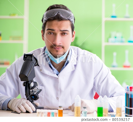 Man chemist working in the lab 80539257
