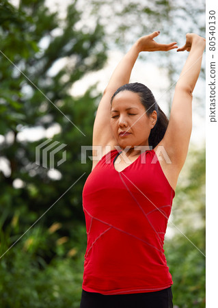 Adult asian woman doing yoga in nature, doing stretching and flexibility exercises, yoga class for adult women Adult asian woman doing yoga in nature, doing stretching and flexibility exercises, yoga class for adult women 80540130