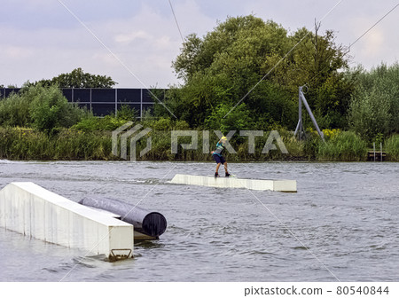 Teenager wakeboarding on a lake - Brwinow, Masovia, Poland 80540844