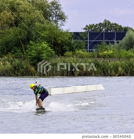 Teenager wakeboarding on a lake - Brwinow, Masovia, Poland 80540848