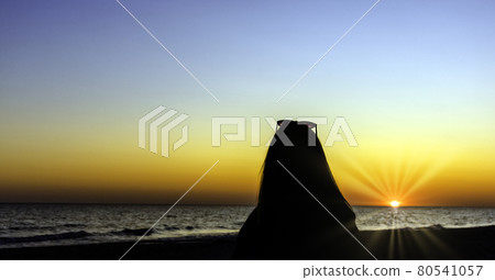 Silhouette of a girl with sunset over Baltic Sea in Lubiatowo, Pomerania, Poland Silhouette of a girl with sunset over Baltic Sea in Lubiatowo, Pomerania, Poland 80541057