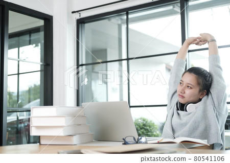 Young student in casual suit reading and doing stretch oneself Young student in casual suit reading and doing stretch oneself 80541106