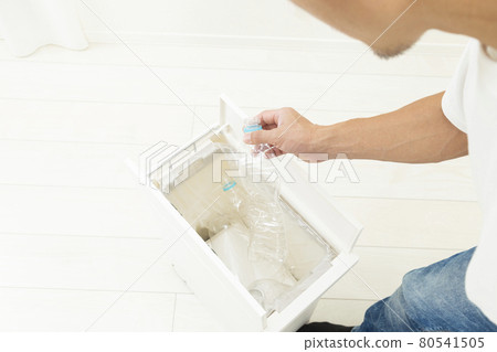 A man throwing away a plastic bottle 80541505