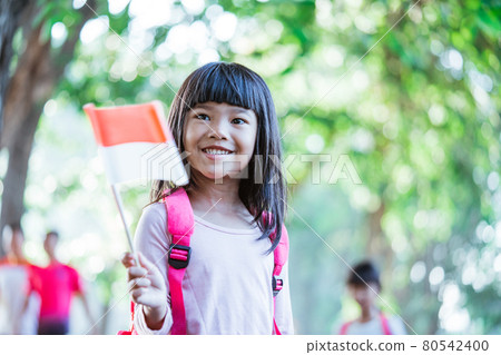 indonesian school student holding flag during independence day. indonesian school student holding flag during independence day. 80542400