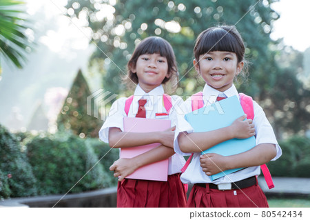 happy student friend in uniform smiling to camera 80542434