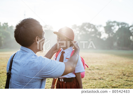 father taking her daughter to primary school in the morning father taking her daughter to primary school in the morning 80542483