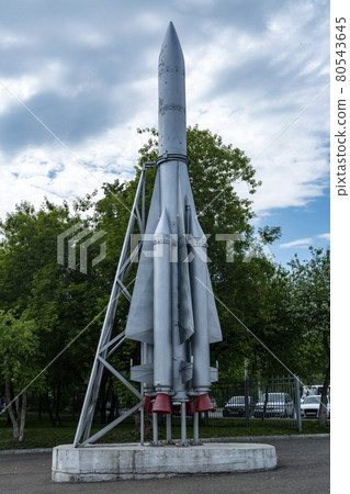 Mock up of a space rocket on a pedestal against the backdrop of a cloudy sky. 80543645