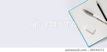 open notebook with blank pages workplace composition, White pencil eraser black pencil for drawing on a white table for school concept with copy space, Top view, flat lay open notebook with blank pages workplace composition, White pencil eraser black pencil for drawing on a white table for school concept with copy space, Top view, flat lay 80544251