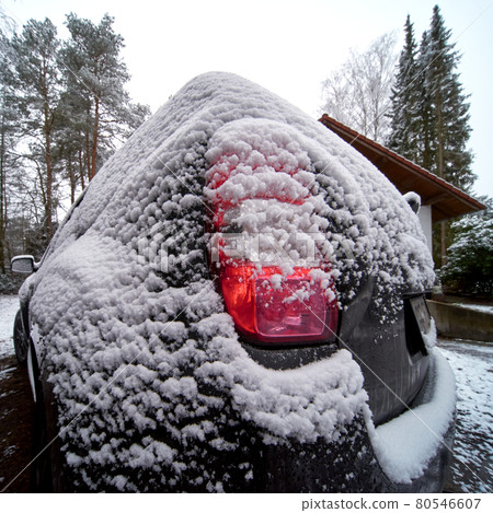 Wide-angle view of the rear tail light of an SUV after a light snowfall. Wide-angle view of the rear tail light of an SUV after a light snowfall. 80546607