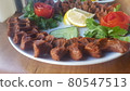 Cig kofte (raw meatball) with lettuce, tomato, pickle and lemon on the white plate. Turkish food Raw Meat ( Cig Kofte ) from traditional Turkish cuisine 80547513