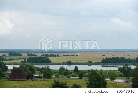 Beautiful cloudy landscape of a Belarusian village Beautiful cloudy landscape of a Belarusian village 80548916