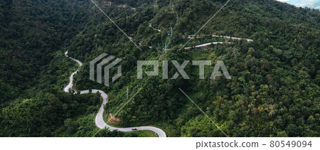 mountain road and green trees from above 80549094