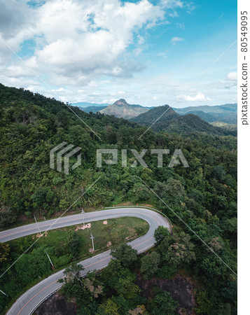 mountain road and green trees from above 80549095