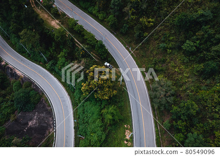 mountain road and green trees from above 80549096