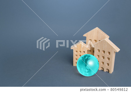 Residential buildings and blue globe. Environmentally friendly housing, minimal impact on environment. Energy efficiency, zero carbon emissions. Carbon neutrality. Internet service communication. IoT 80549812